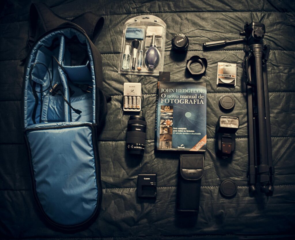 A flat lay of essential camera equipment and accessories for photography.