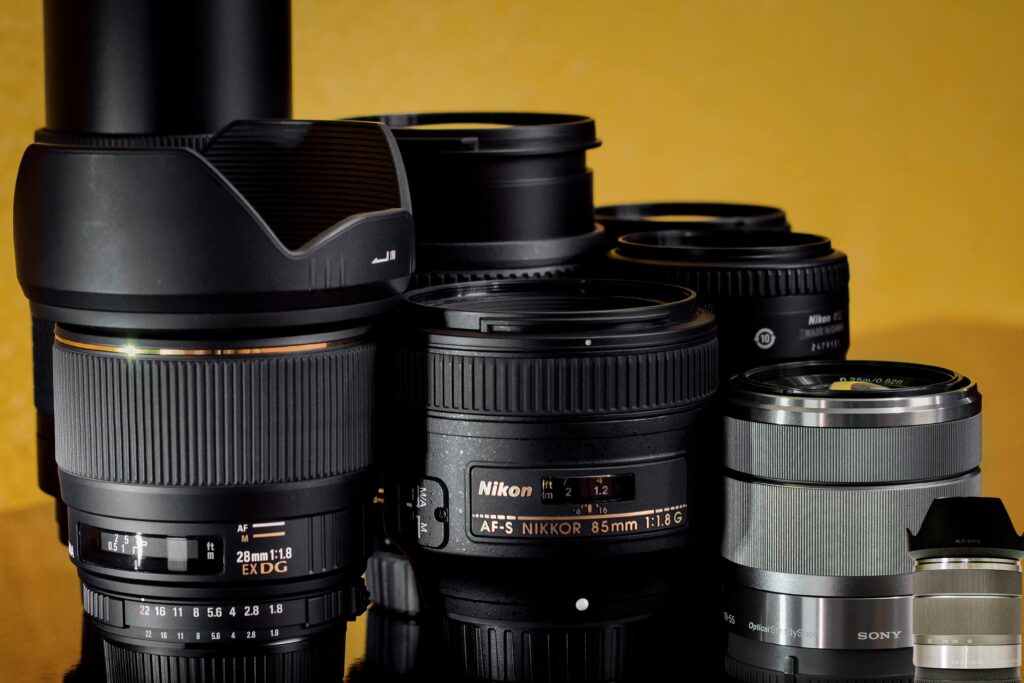 A collection of camera lenses displayed against a yellow background.