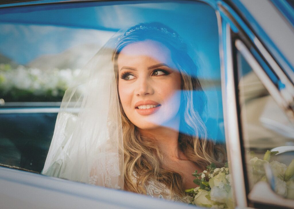 A joyful bride gazing out from a car window in Asunción, Paraguay.